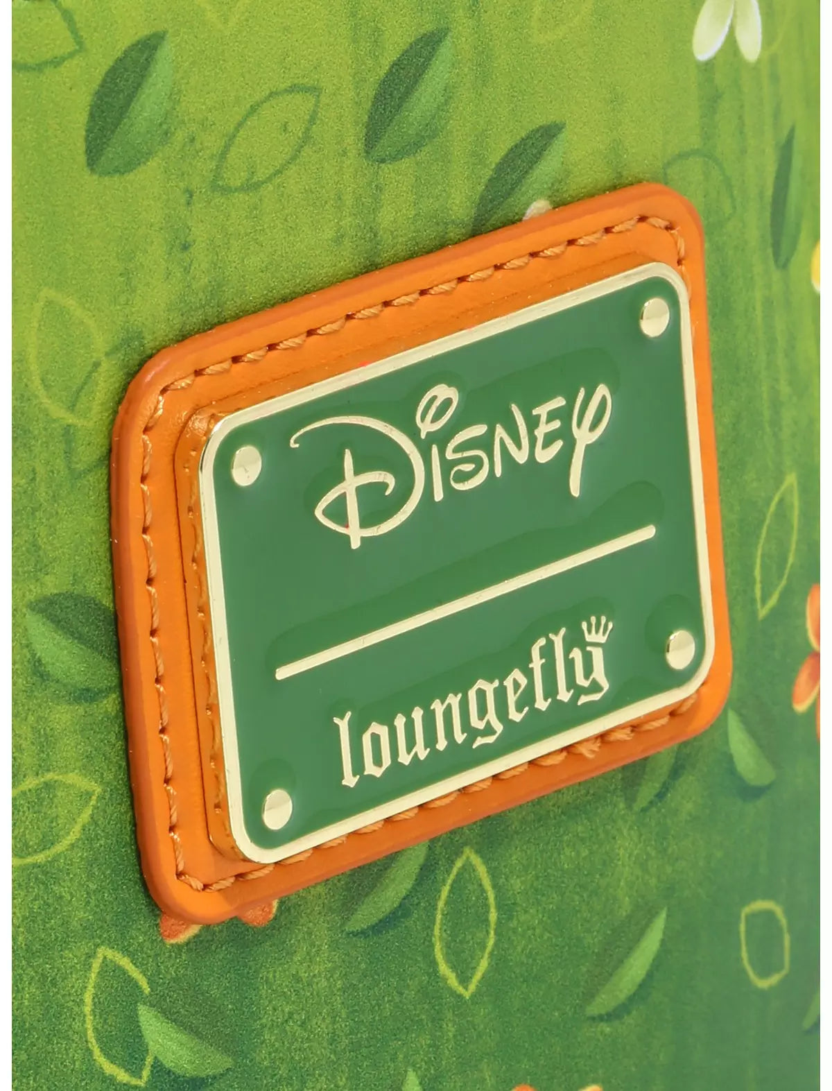 Close-up of Loungefly Disney Moana Te Fiti Mini Backpack with Disney Loungefly logo on a green background with leaf patterns
