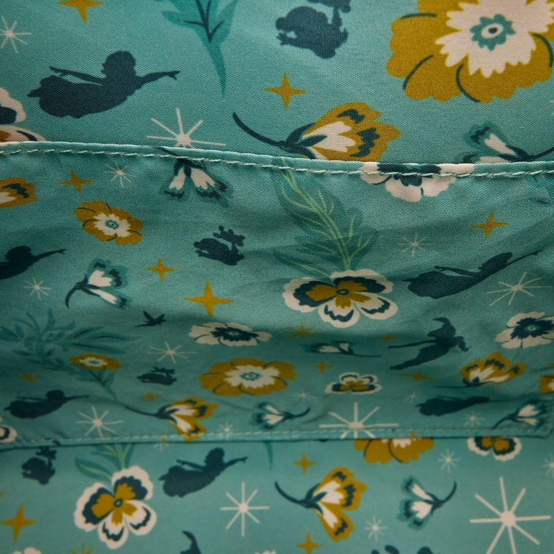 Close-up of inside of Green embroidered Loungefly Disney Peter Pan Quilted Texture Crossbody Bag with fabric with fairy and floral pattern on a teal background