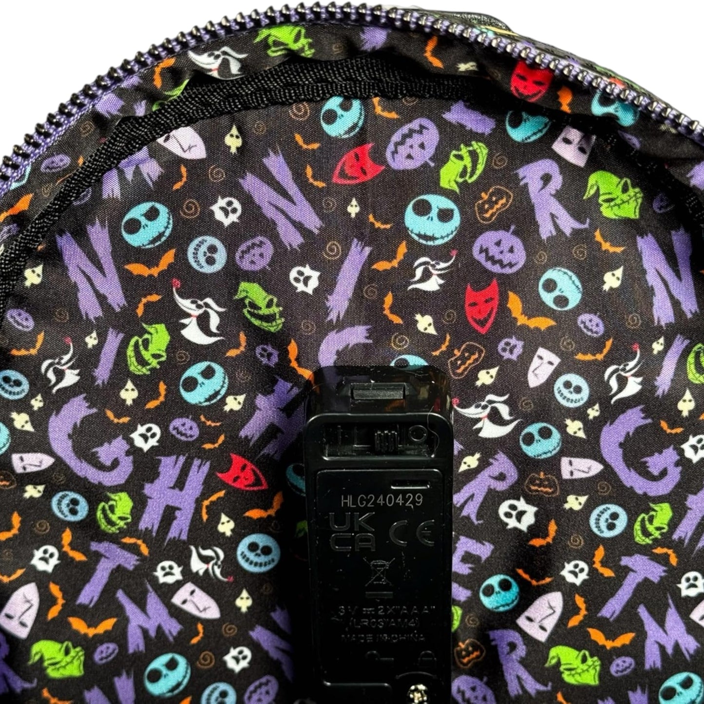 Backpack with colorful NBC-themed pattern on a black background