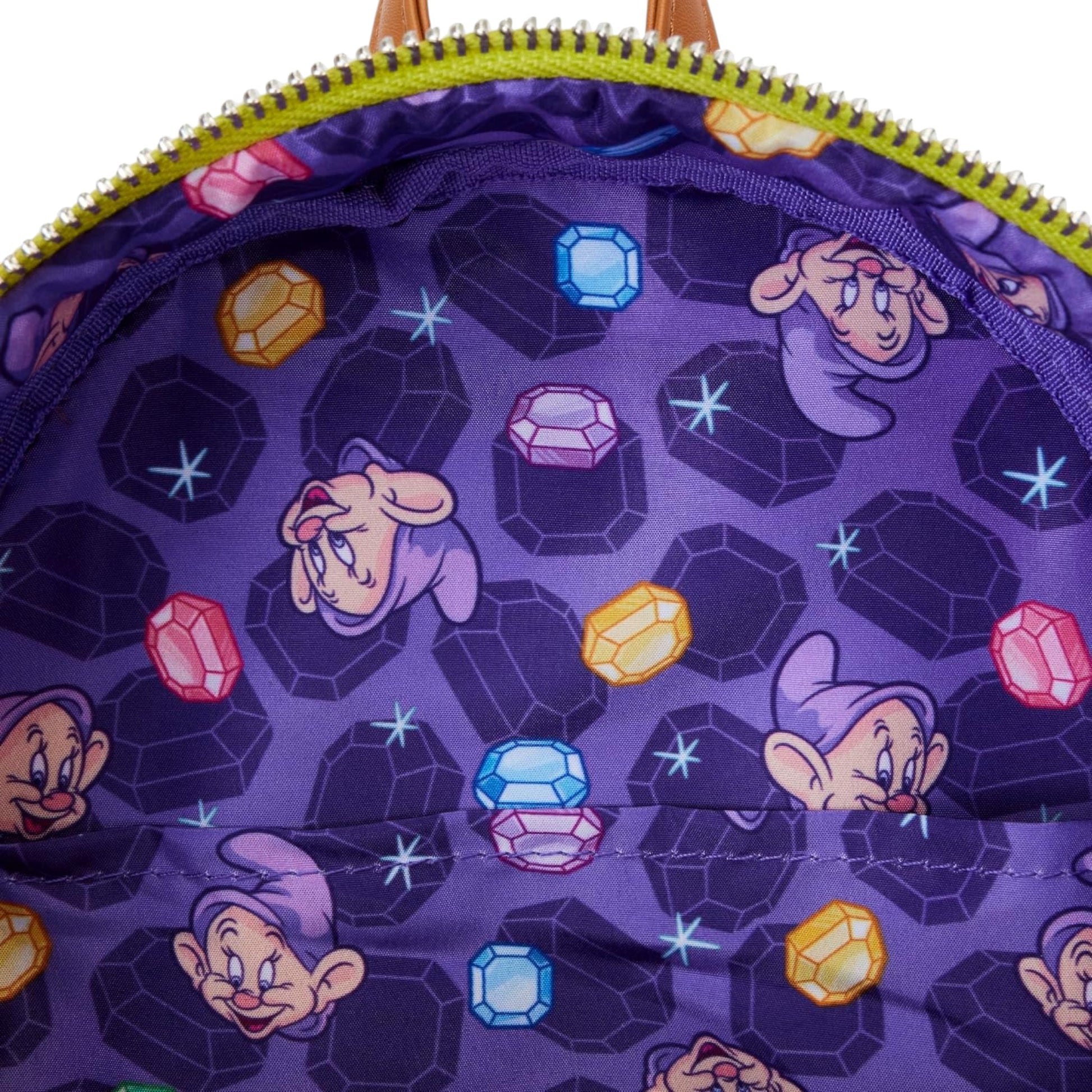 Close-up of a purple fabric with dopey characters and gemstones.