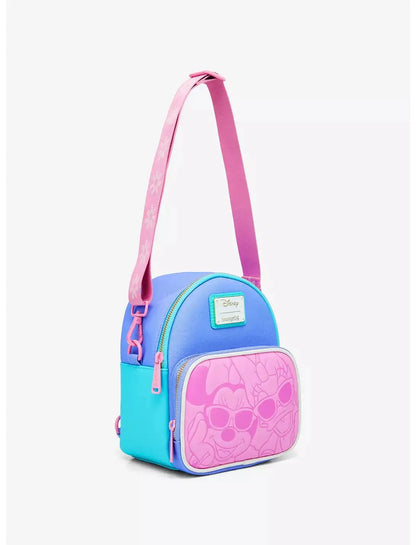 Crossbody view of blue and pink bag with Minnie Mouse and Daisy Duck on a white background