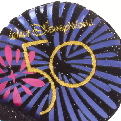 50th anniversary logo with 'Walt Disney World' text on a circular design with blue and pink colors.