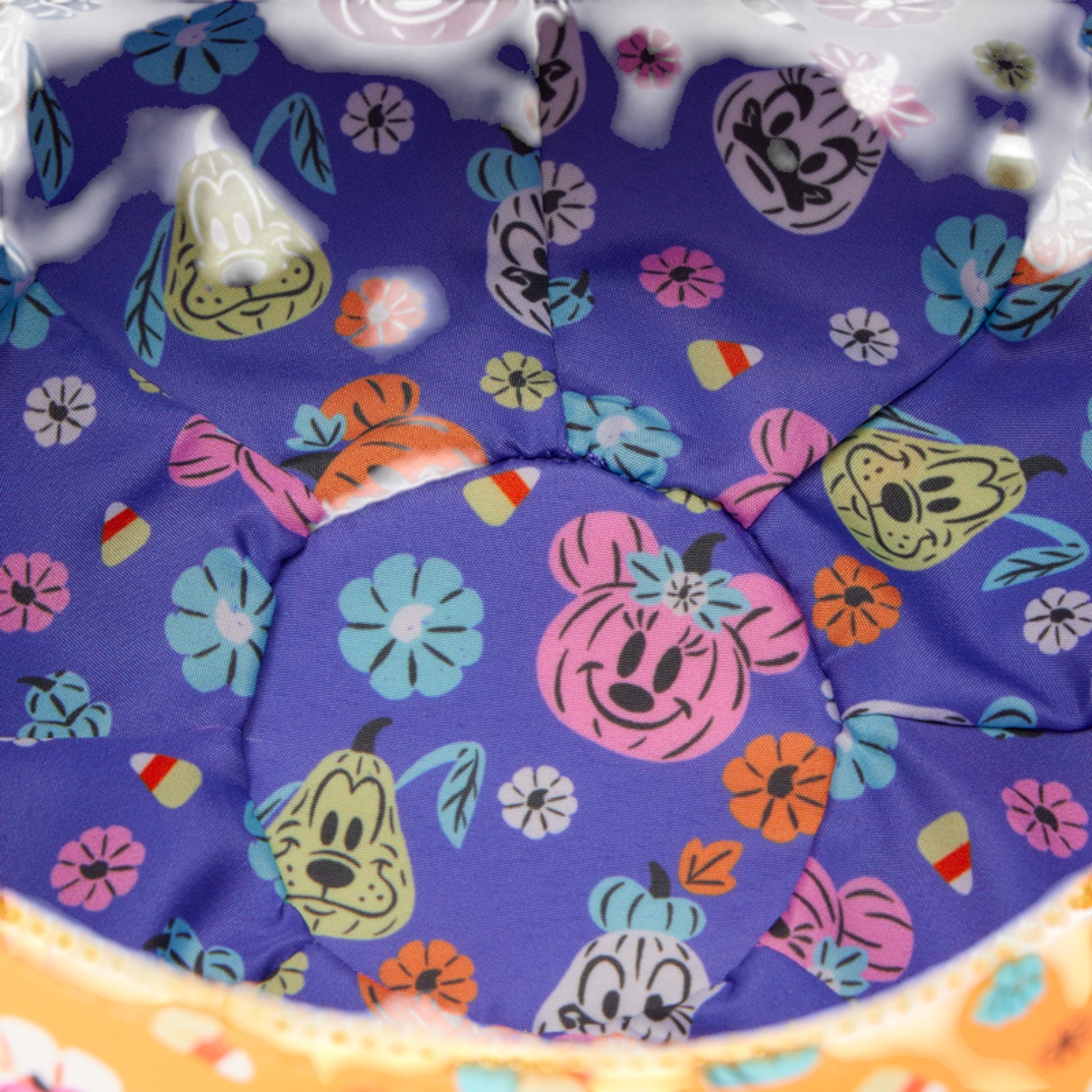 Colorful fabric with mickey and friends character patterns on a purple background