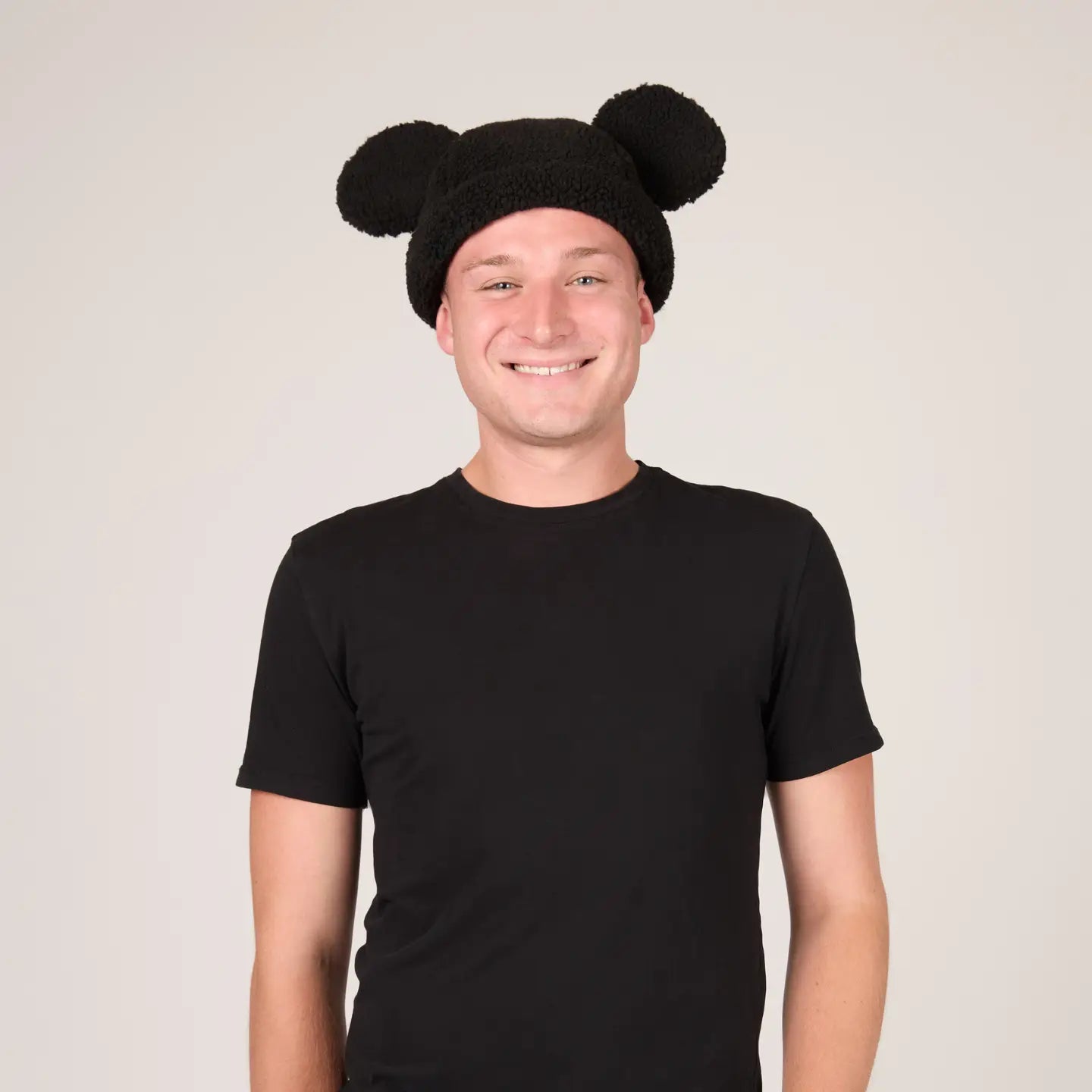 Person wearing a Mickey Sherpa Beanie Classic Black with Mickey ears on a plain background