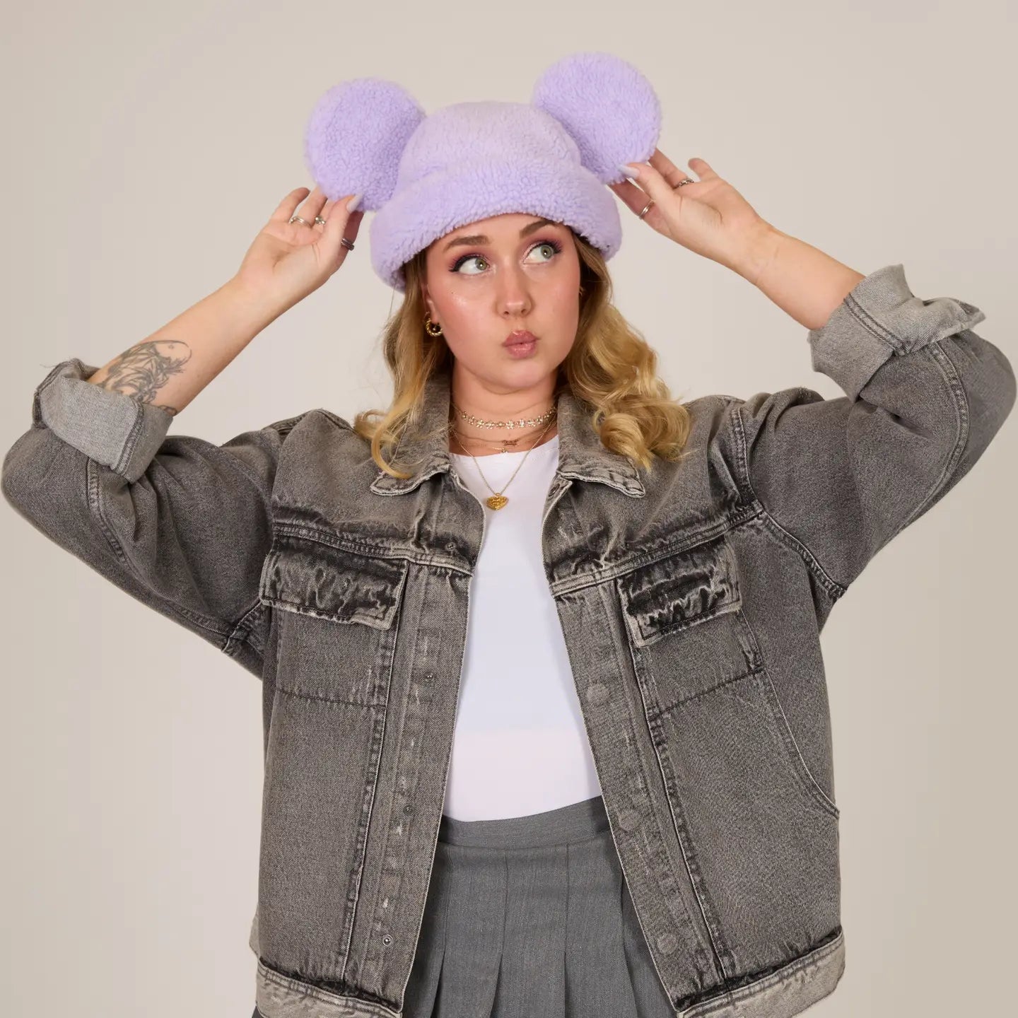 Person wearing a gray denim jacket and Mickey Sherpa Beanie Lavender with Mickey ears