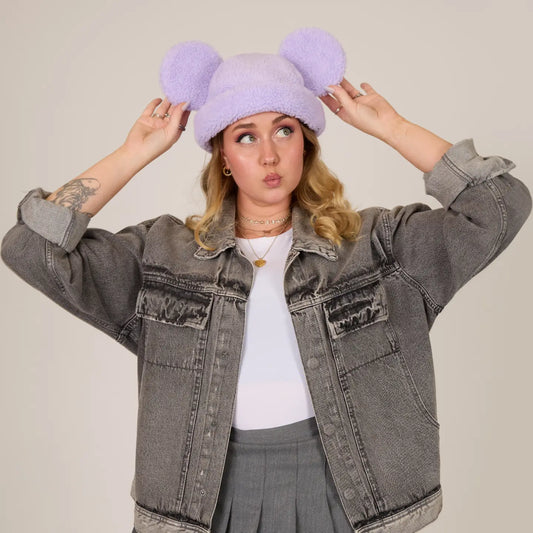 Person wearing a gray denim jacket and Mickey Sherpa Beanie Lavender with Mickey ears