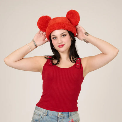 Woman wearing a Mickey Sherpa Beanie Strawberry hat with Mickey ears against a beige background