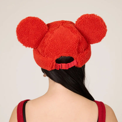 Mickey Sherpa Beanie Strawberry hat with Mickey ears worn by a person on a plain background