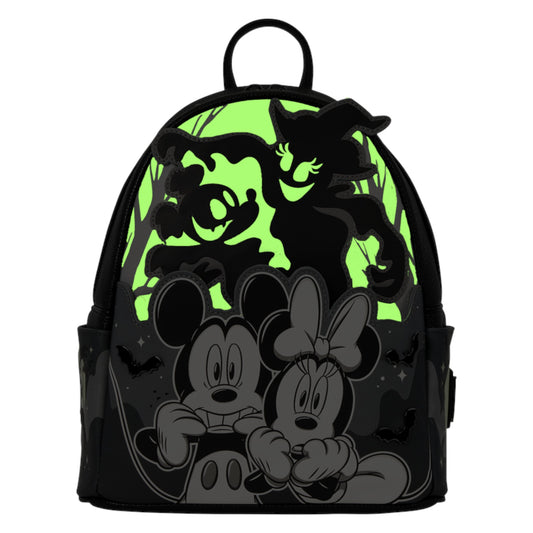 A black backpack featuring a Halloween-themed graphic print with Mickey Mouse and Minnie Mouse in the foreground, a green glowing moon, and black cartoon ghosts in the background.