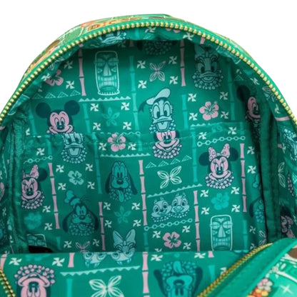 Green backpack with Mickey and Friends Tiki character pattern on a white background
