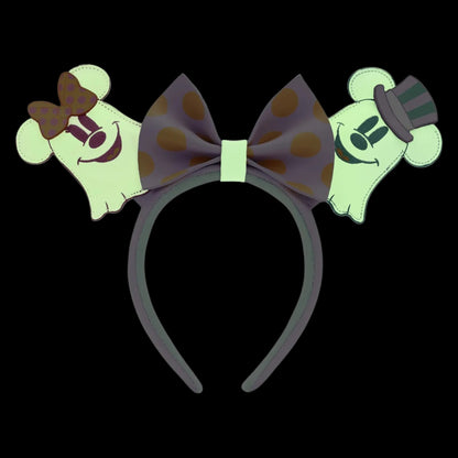 Ghost Minnie & Mickey ears headband with polka dot bow and ghost designs glowing on a black background