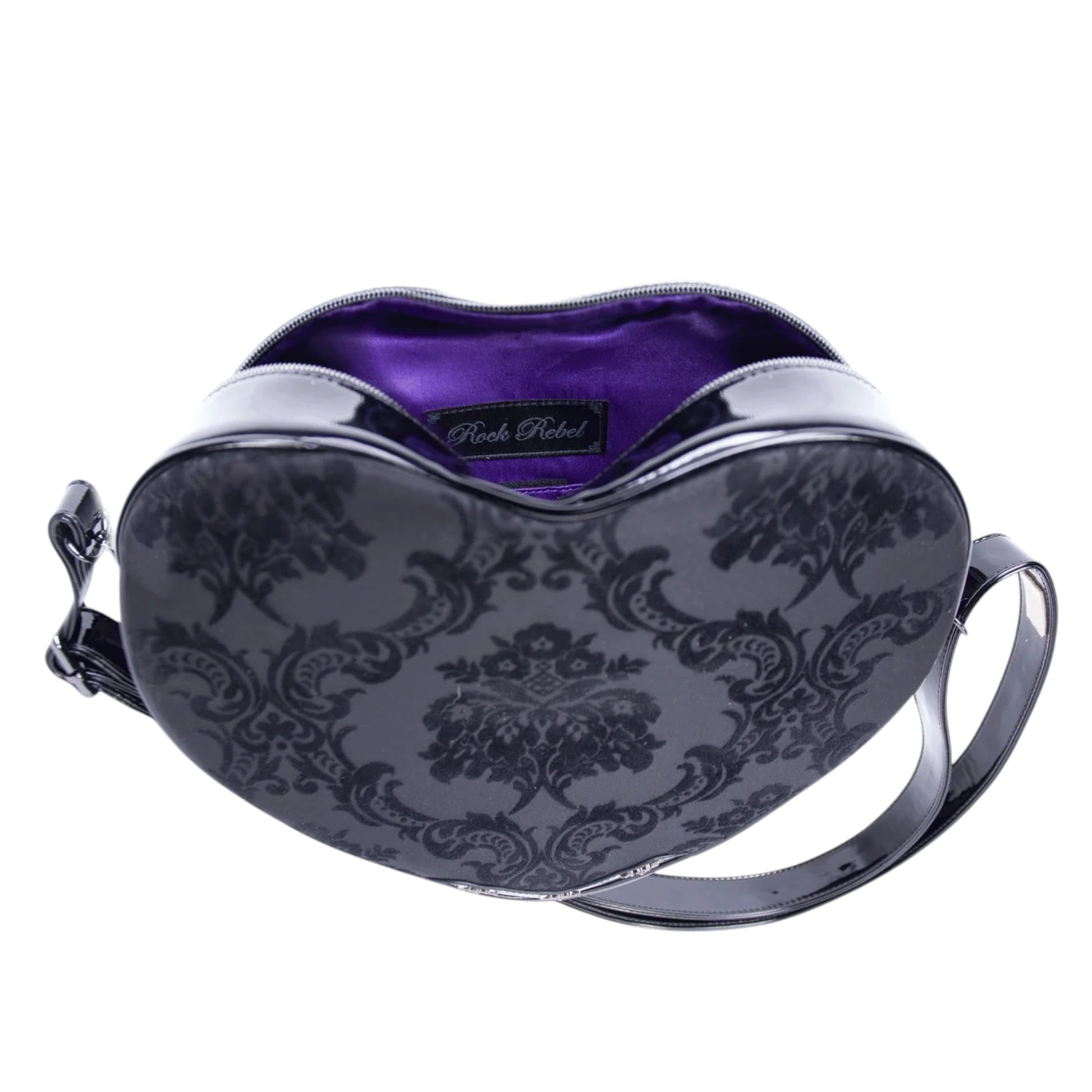 Heart-shaped handbag with purple interior and black floral pattern on a white background