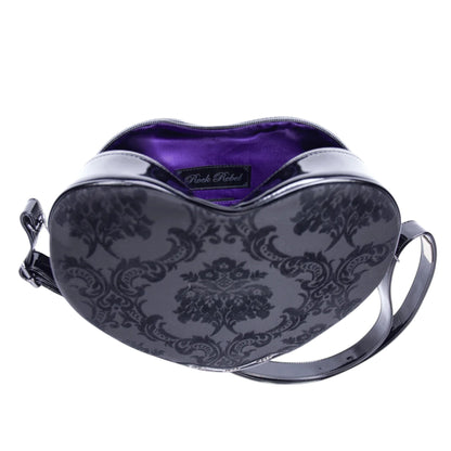 Heart-shaped handbag with purple interior and black floral pattern on a white background