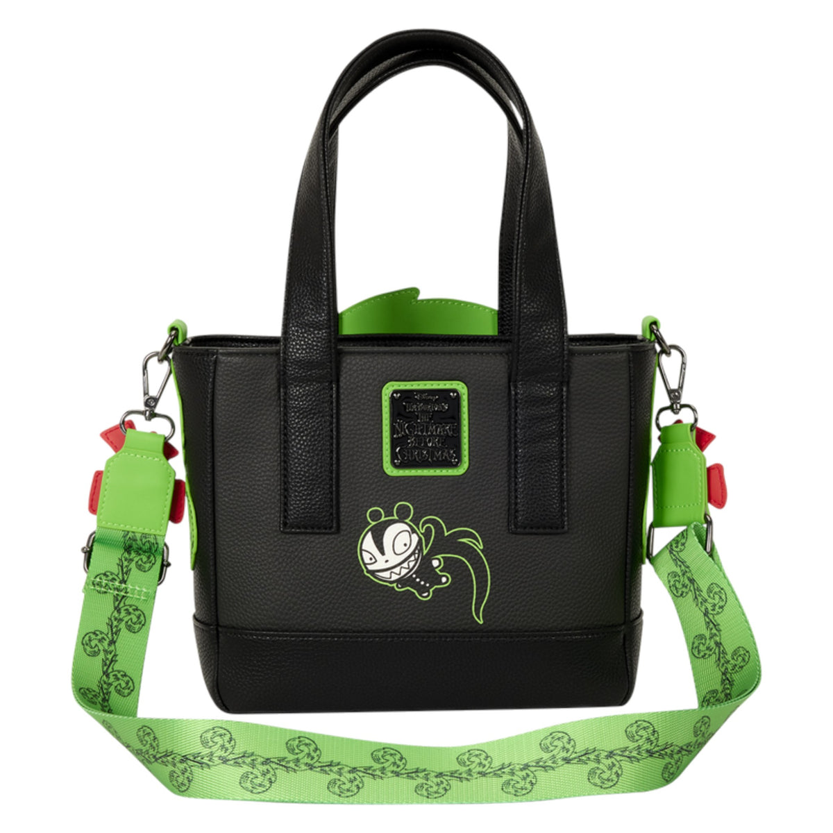 A black faux-leather tote bag with a bright green patterned shoulder strap, featuring a cartoon character patch on the front and a green logo plaque.
