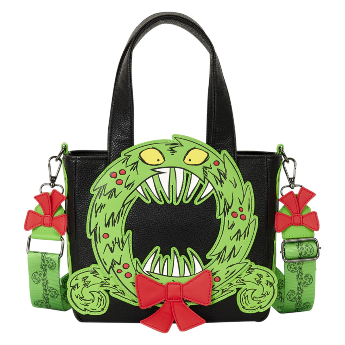 Black faux-leather handbag featuring a large green monster mouth wreath graphic with red bows and yellow eyes, plus matching green patterned shoulder straps with red bow charms.