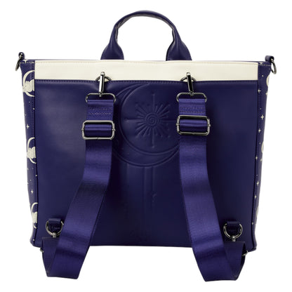 A structured tote bag in deep purple with a cream-colored top panel, featuring a large embossed sun face on the front, dual adjustable shoulder straps with silver buckles, and moon and star patterns printed along the side panels.