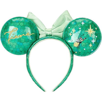 Green Minnie Mouse ears with bow and 'Tiana' text on a stained glass design on a white background