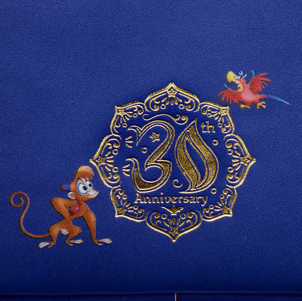 Blue background with gold embroidery of a monkey, bird, and '30th Anniversary' design
