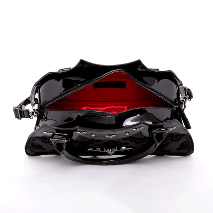 Top view of opened black bat shaped bag with red interior on a white background