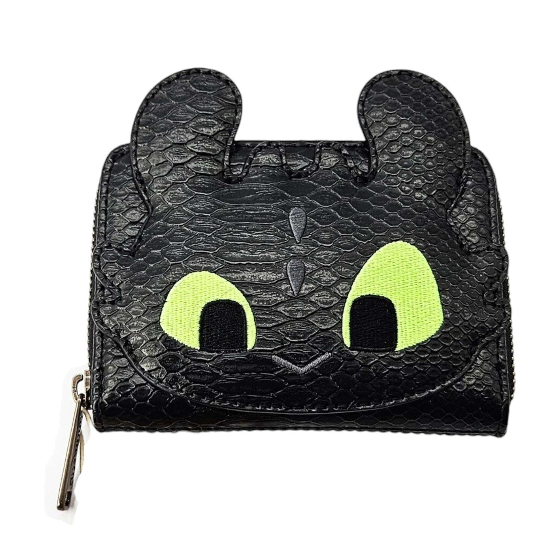 Black dragon-shaped Toothless wallet with green eyes, fom How to Train Your Dragon on a white background