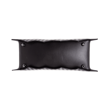 Bottom view of pinstripe bat shaped bag with metal feet  on a white background