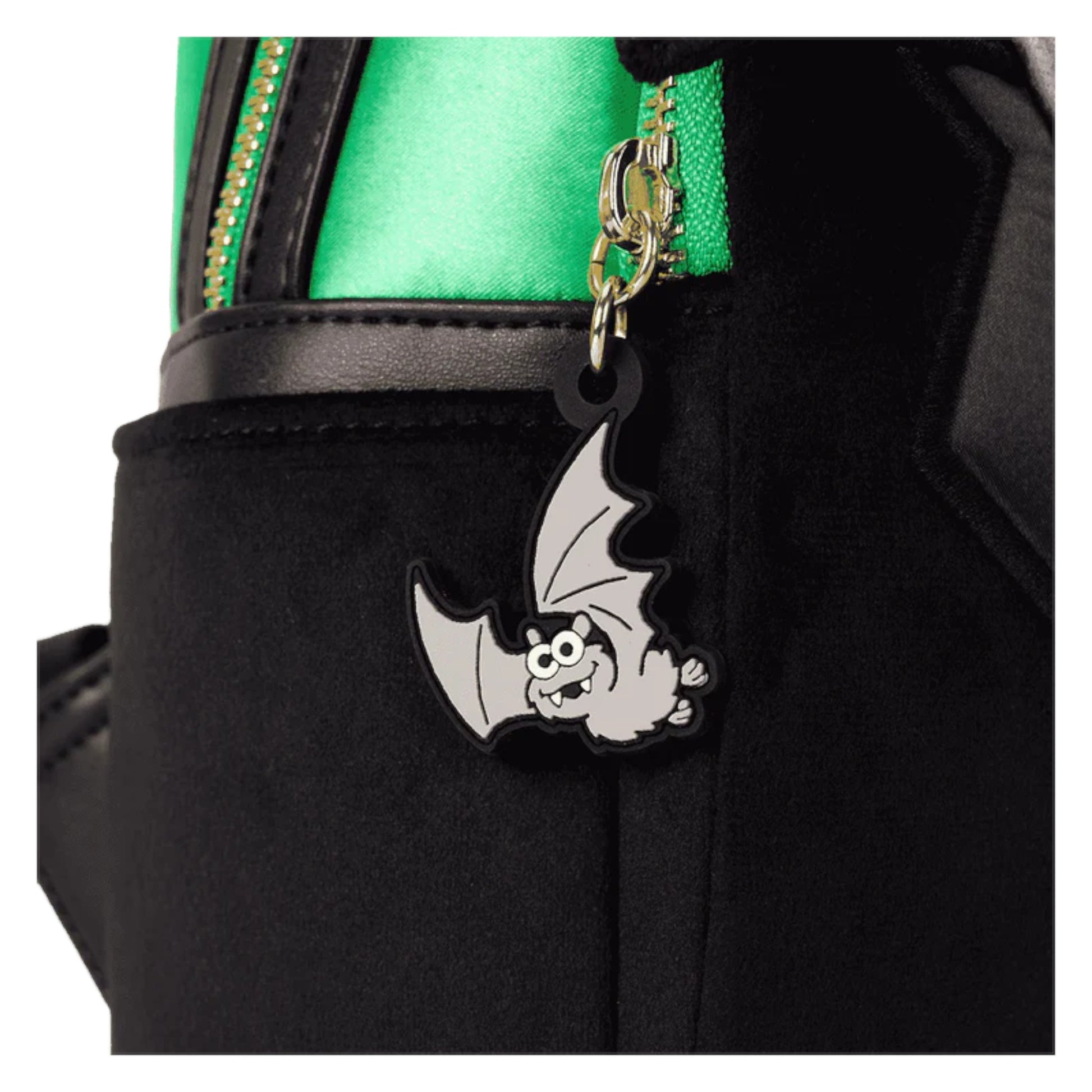 Black bag with a cartoon bat charm on a green background