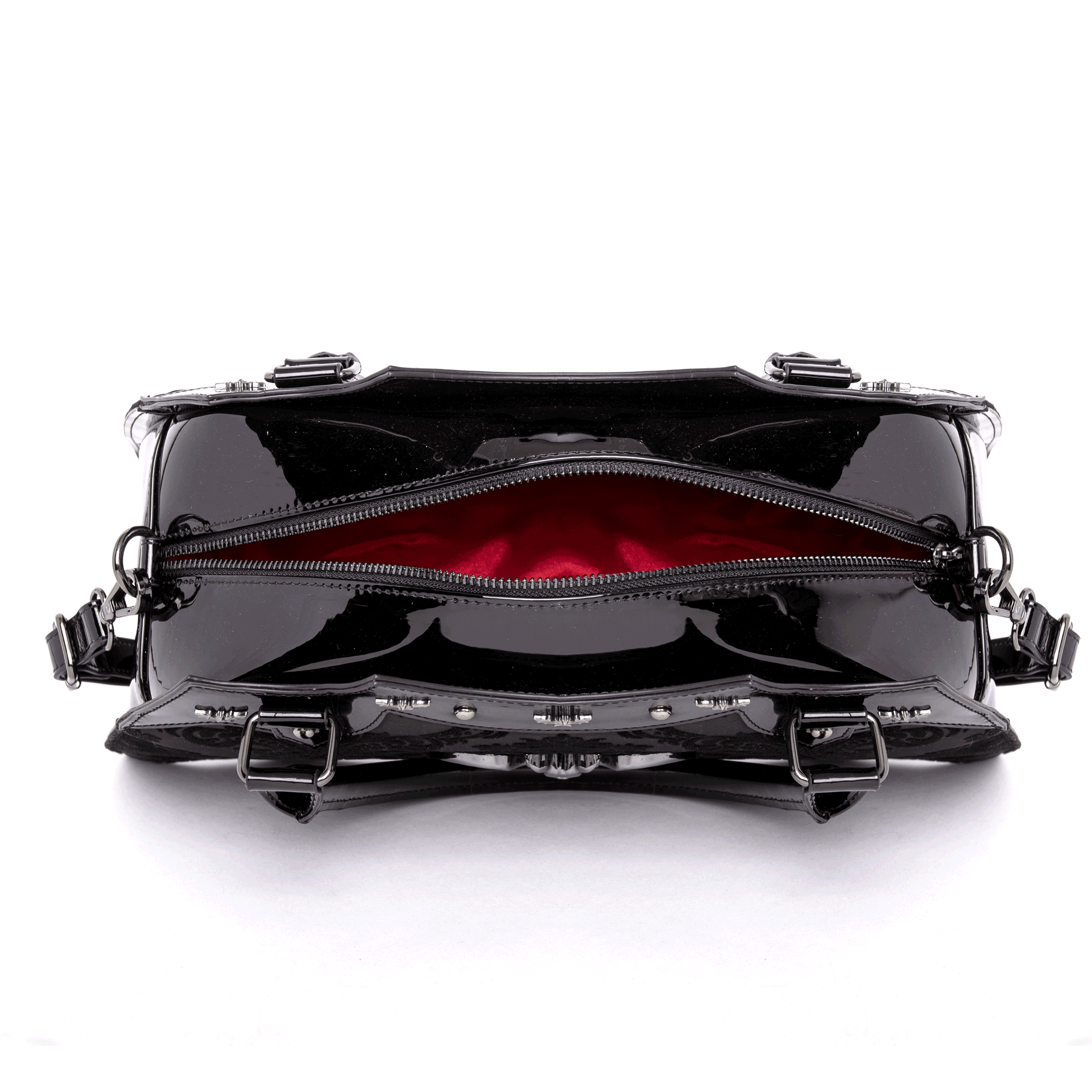 Top view of opened black bat shaped bag with red interior on a white background