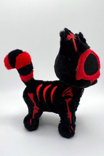 Black and red plush cat on a white background