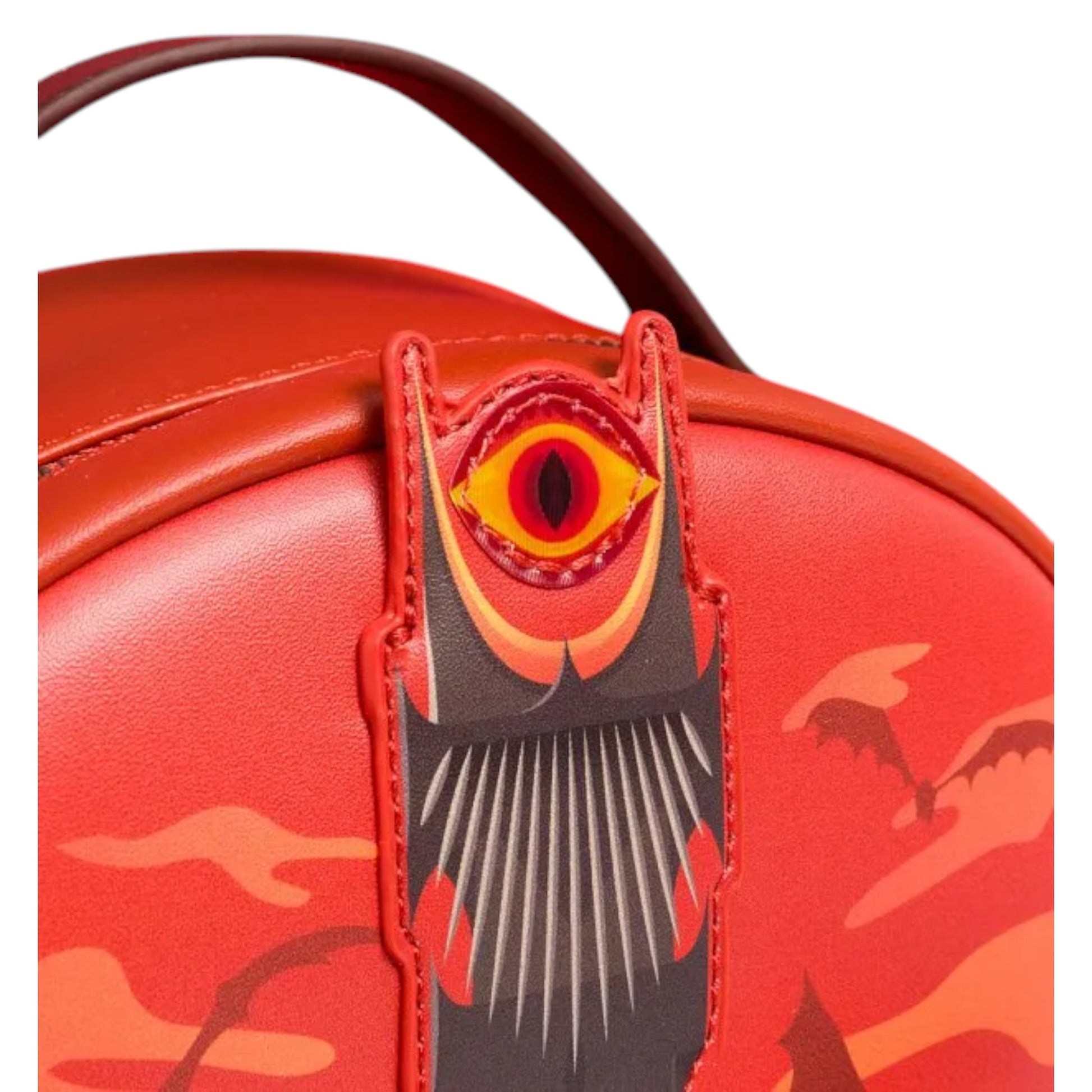 Red handbag with a ring-shaped tag featuring a large eye on a white background