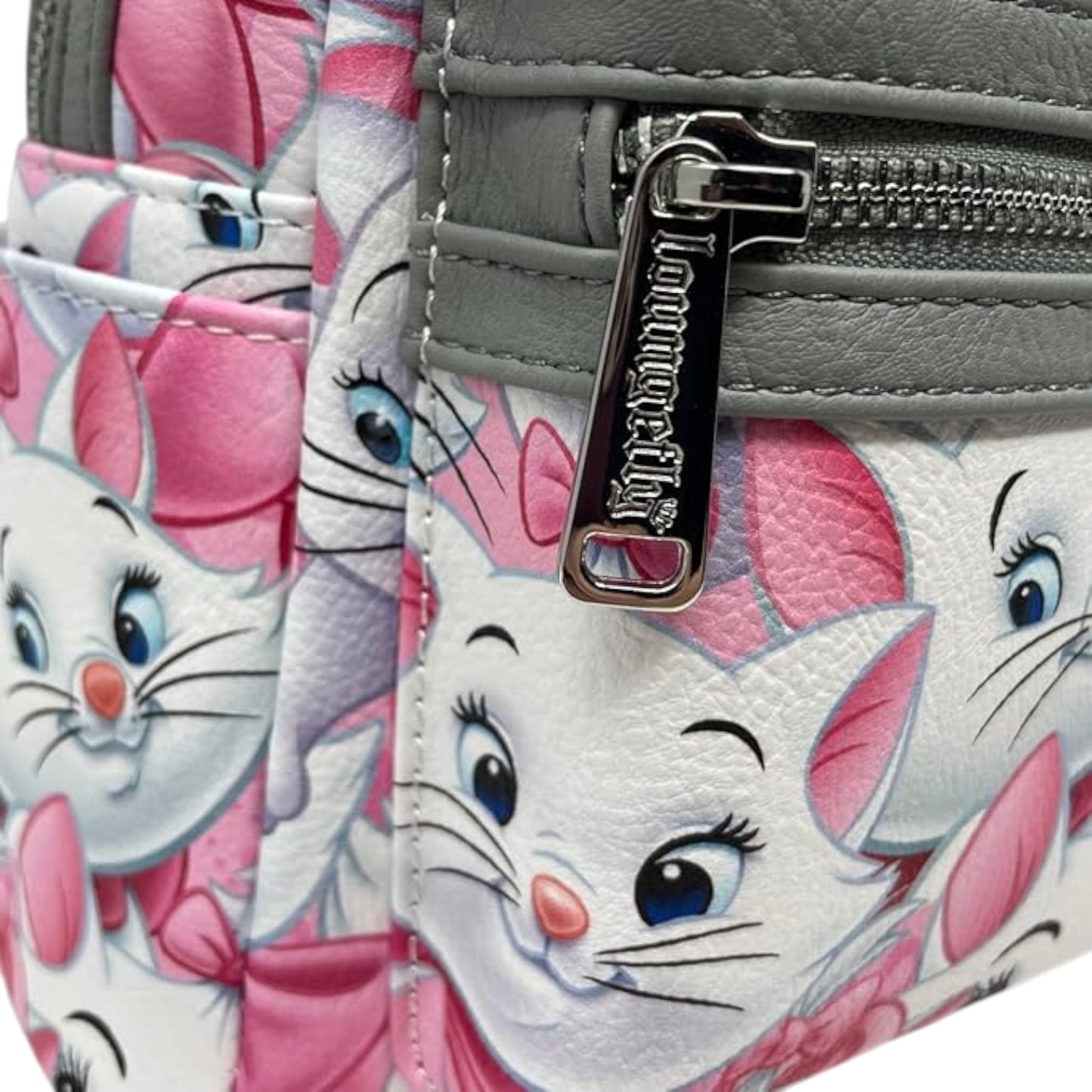 Picture of zipper with a Marie character design featuring a pink bow, and gray background.