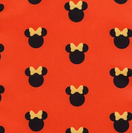 Pattern of black minnie mouse ears with yellow bows on a red background