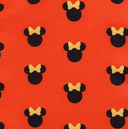 Pattern of black minnie mouse ears with yellow bows on a red background